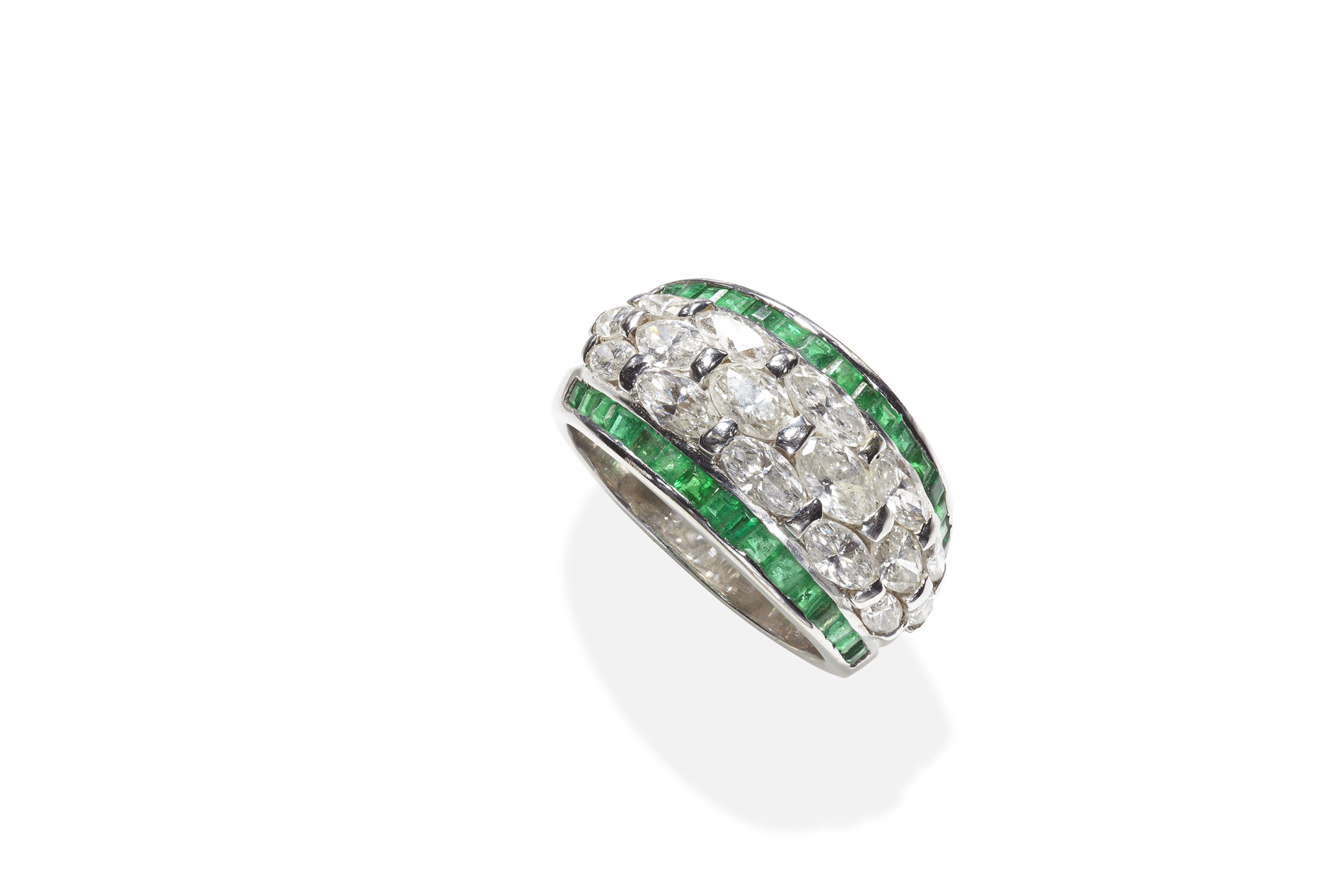 An emerald and diamond cluster ring