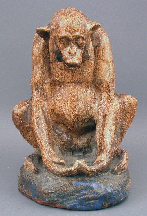 A glazed earthenware figure of an ape