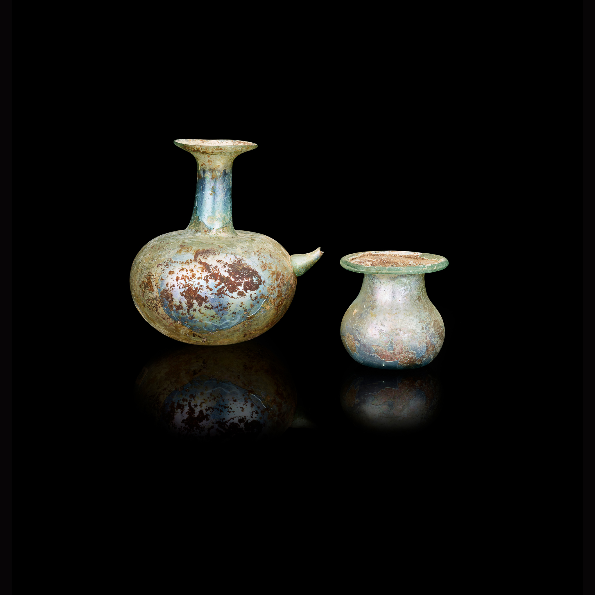 TWO ROMAN GLASS BEAKERS