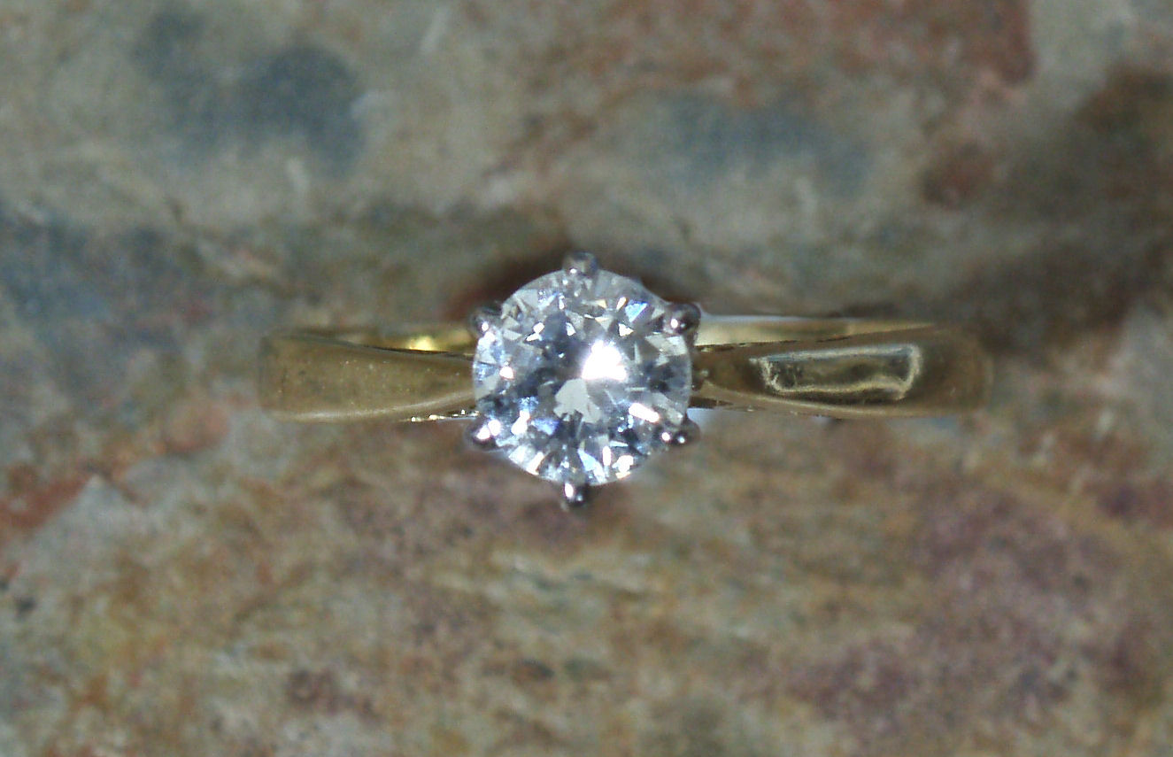 An 18ct gold mounted diamond single-stone ring,