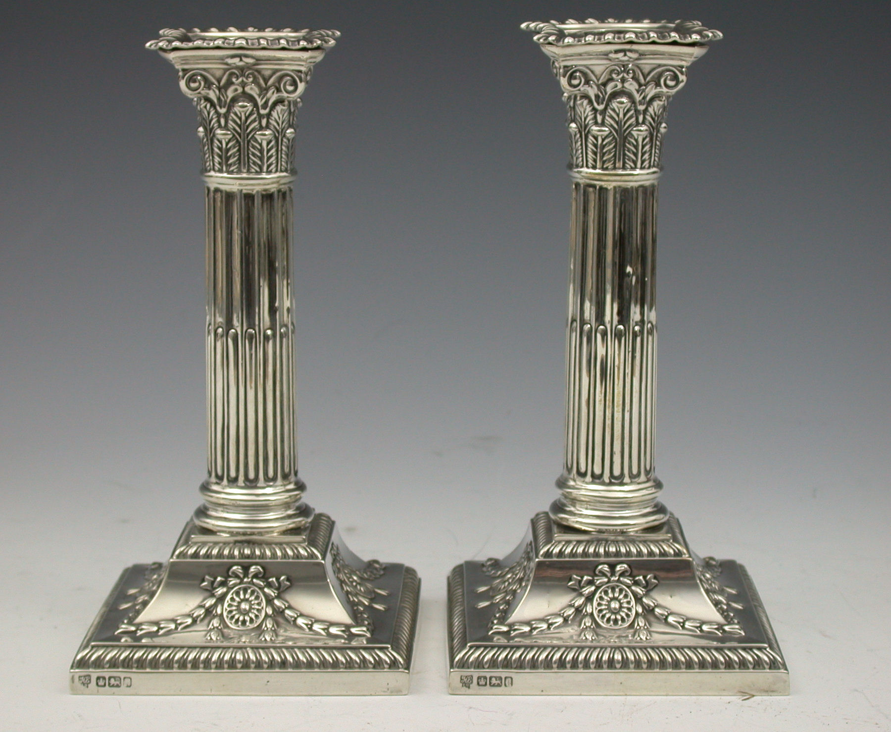 A pair of Edwardian candlesticks,