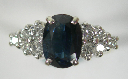 An 18ct gold mounted sapphire and diamond cluster ring,