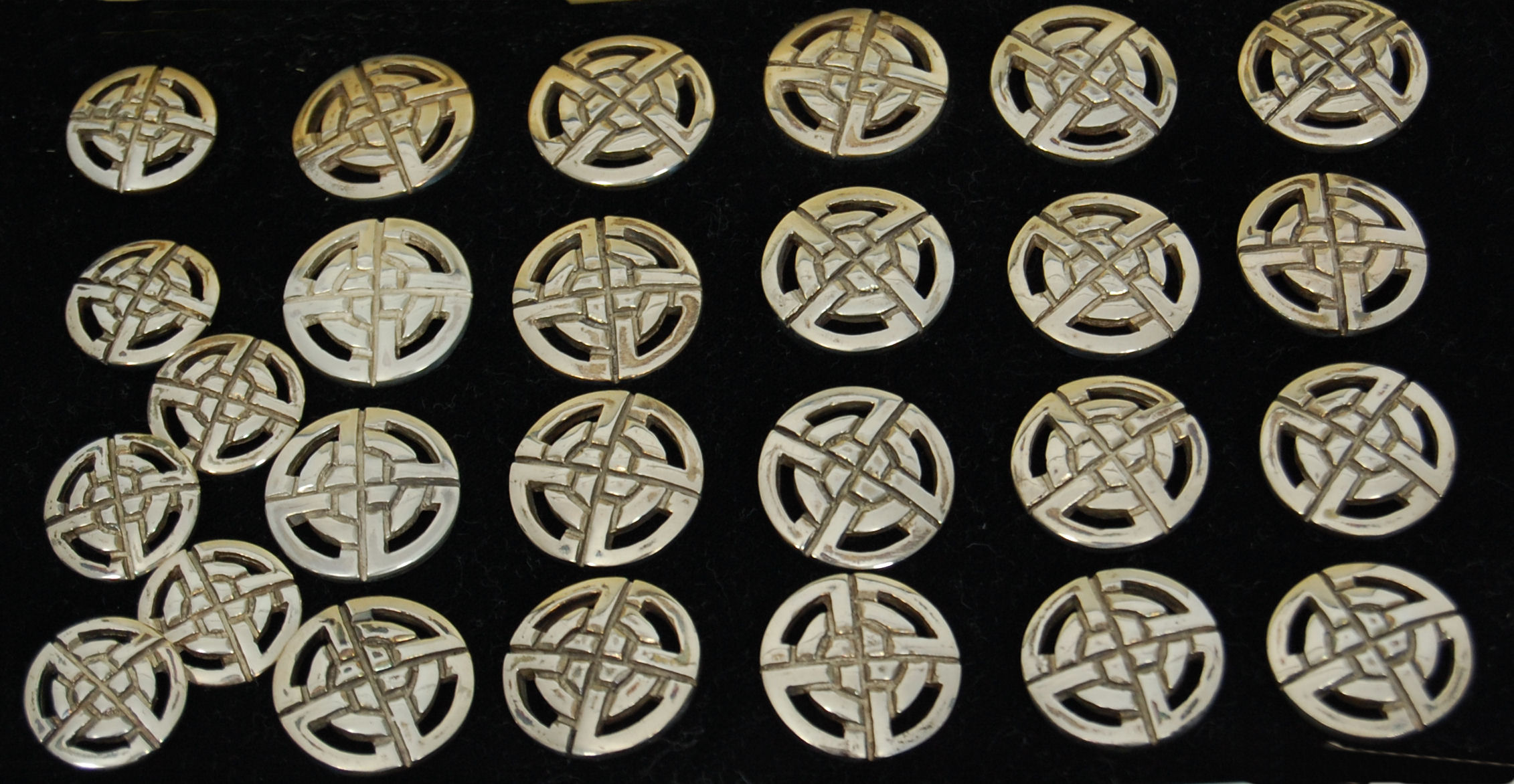 A cased set of Scottish highland dress buttons