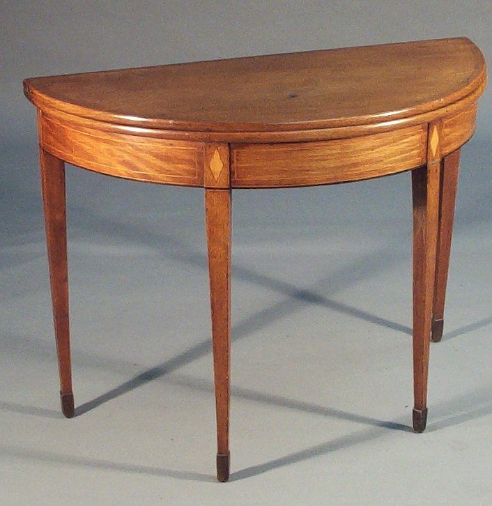 A 19th century mahogany and boxwood strung demi lune tea table