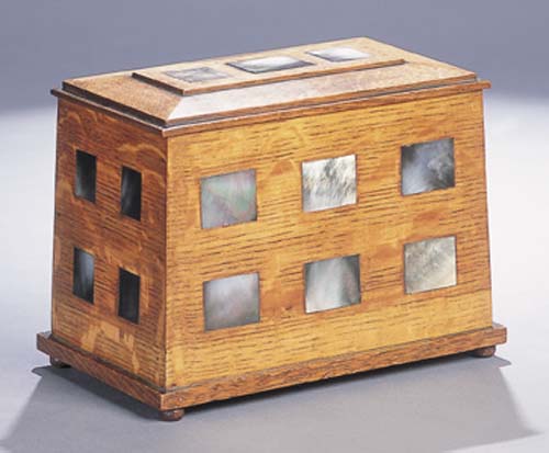 An Arts and Crafts oak and mother of pearl inlaid jewellery casket