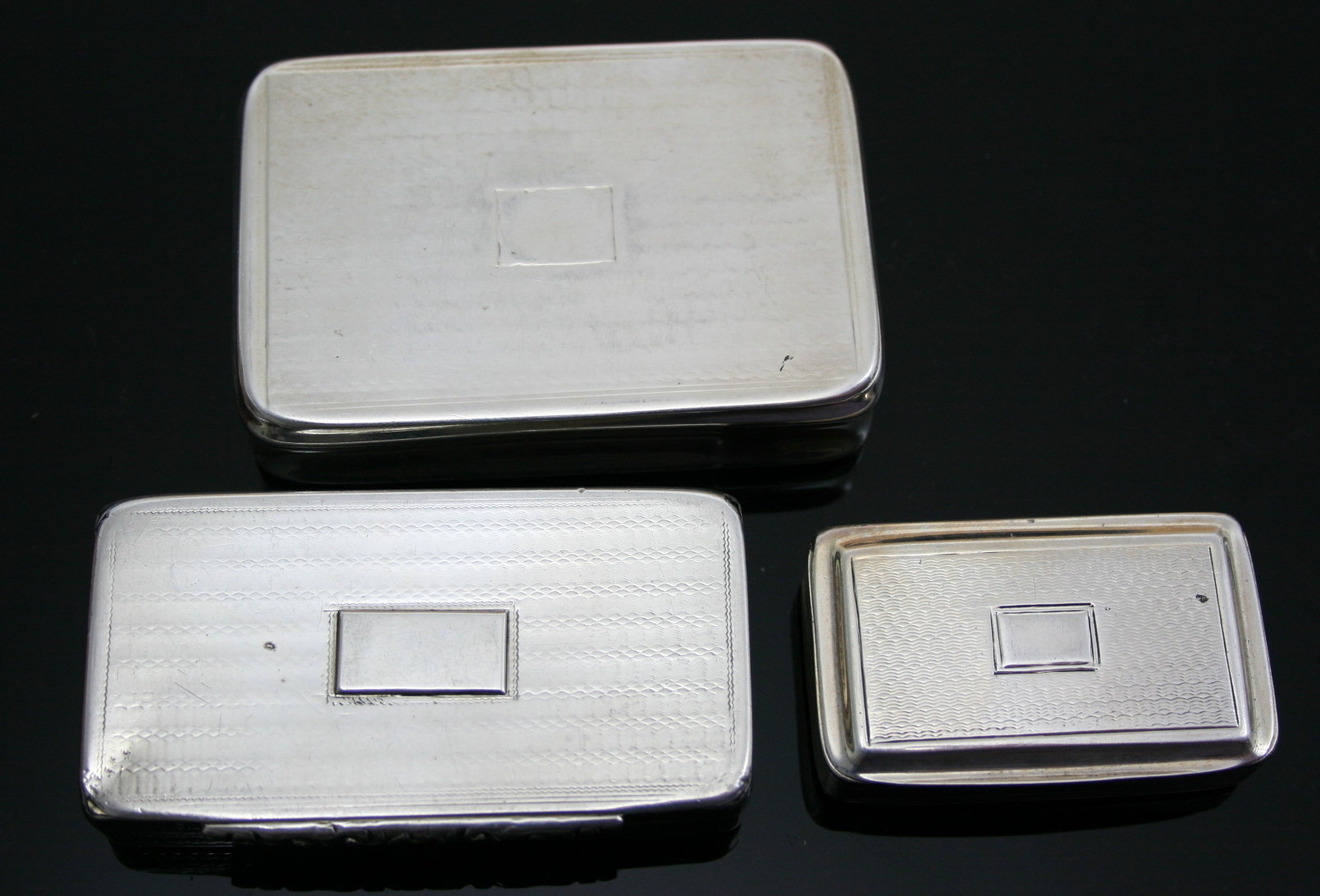 A group of three silver snuff boxes