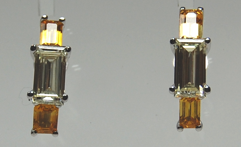 A modern pair of yellow sapphire and diamond earrings,