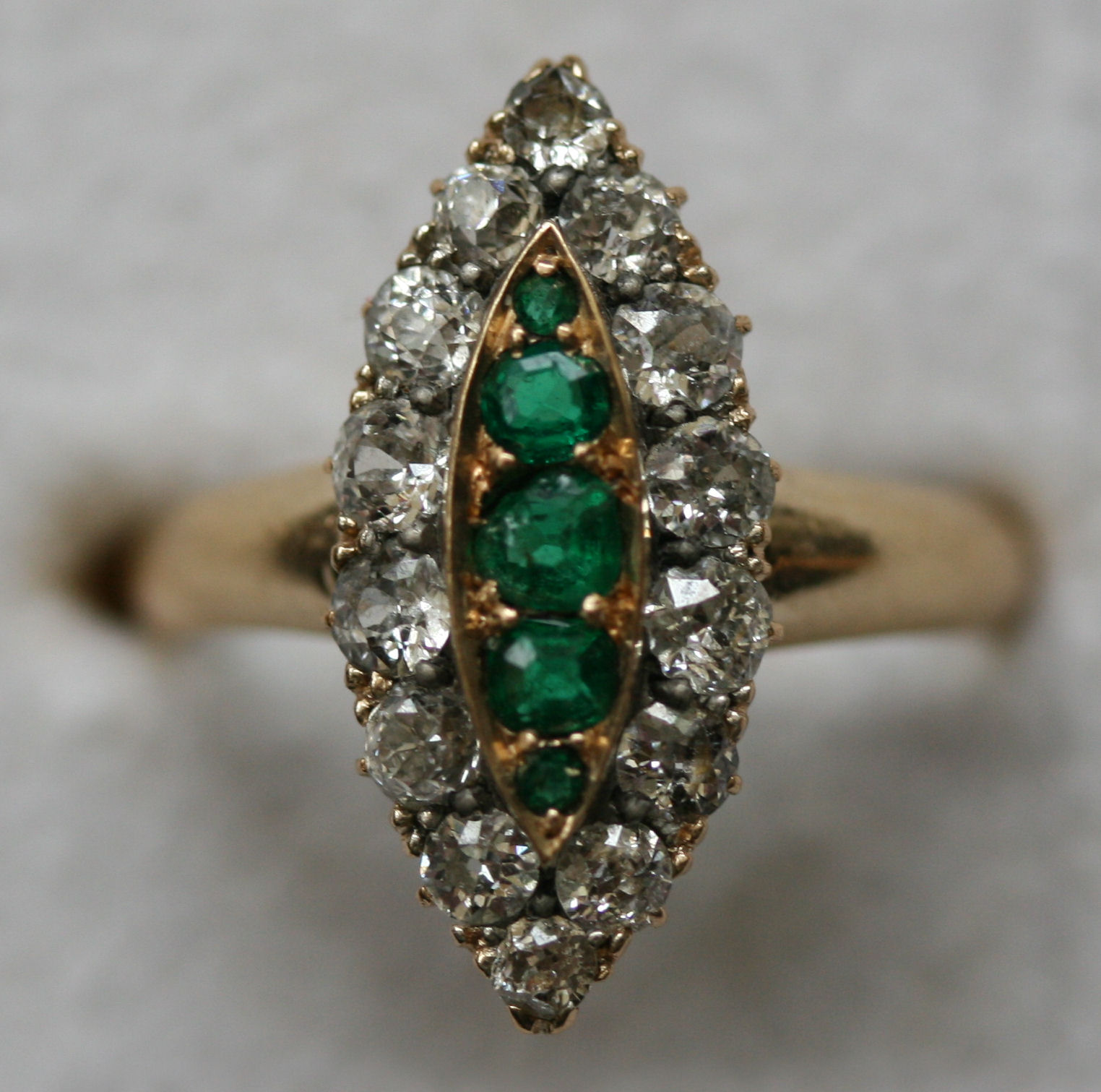 A late Victorian diamond and emerald ring