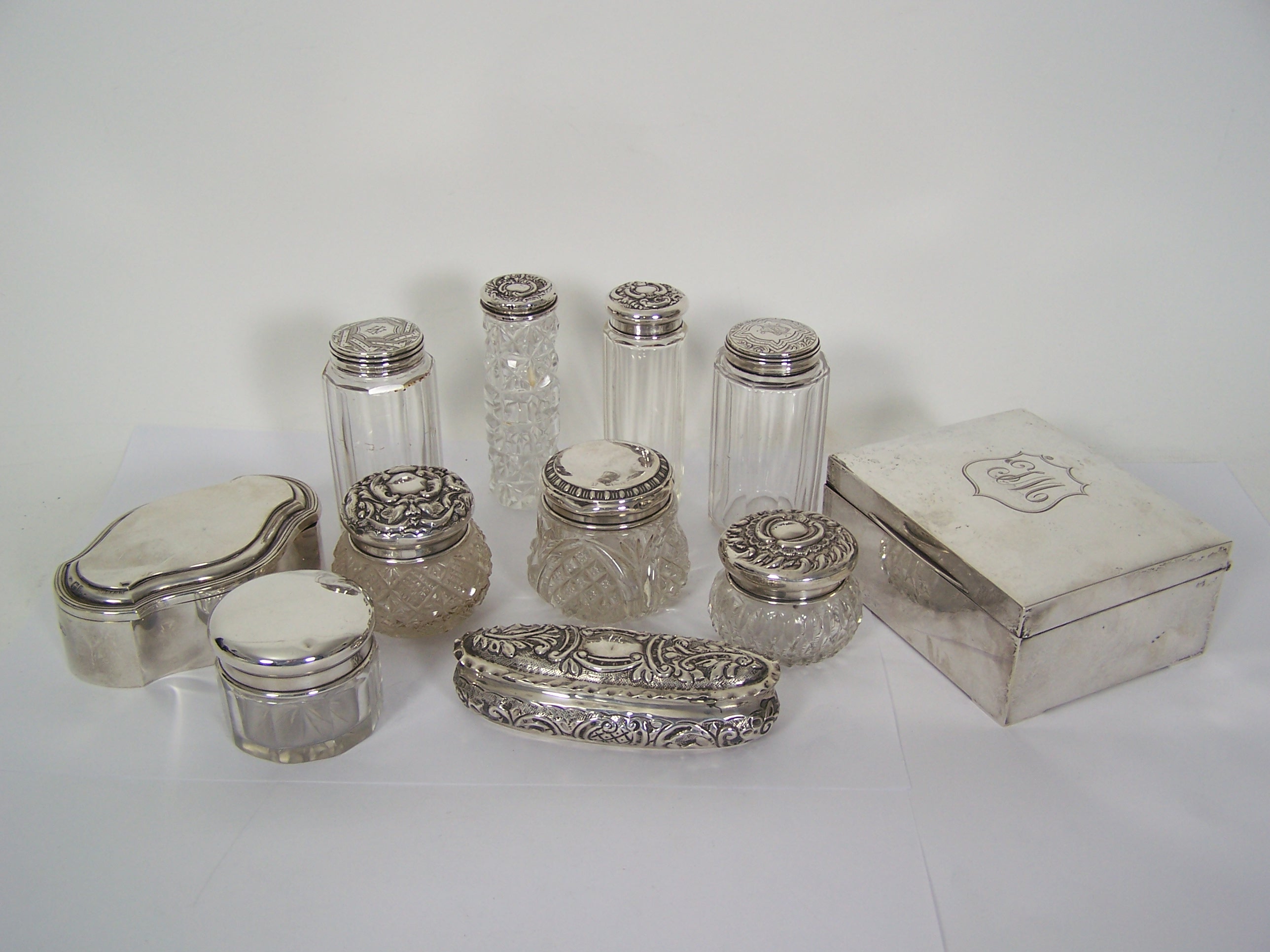 A collection of glass and silver mounted bottles