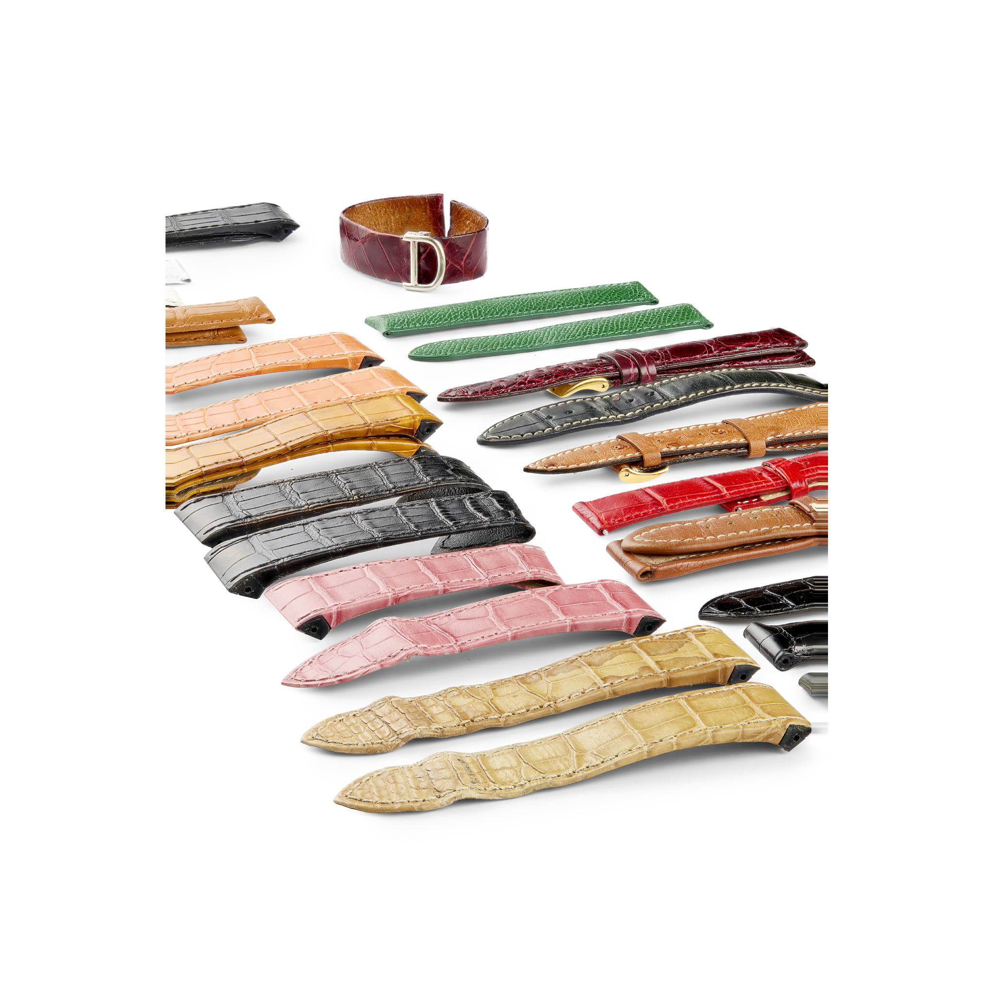 A collection of watch straps including a gold folding buckle
