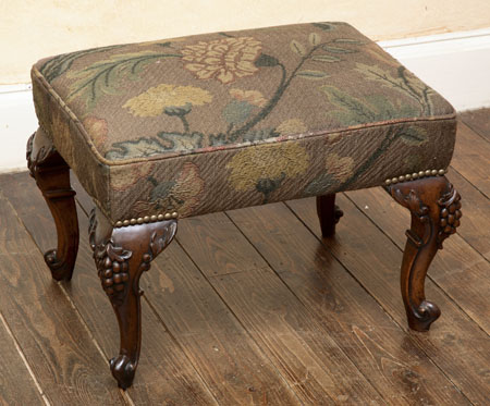 A mahogany and upholstered stool