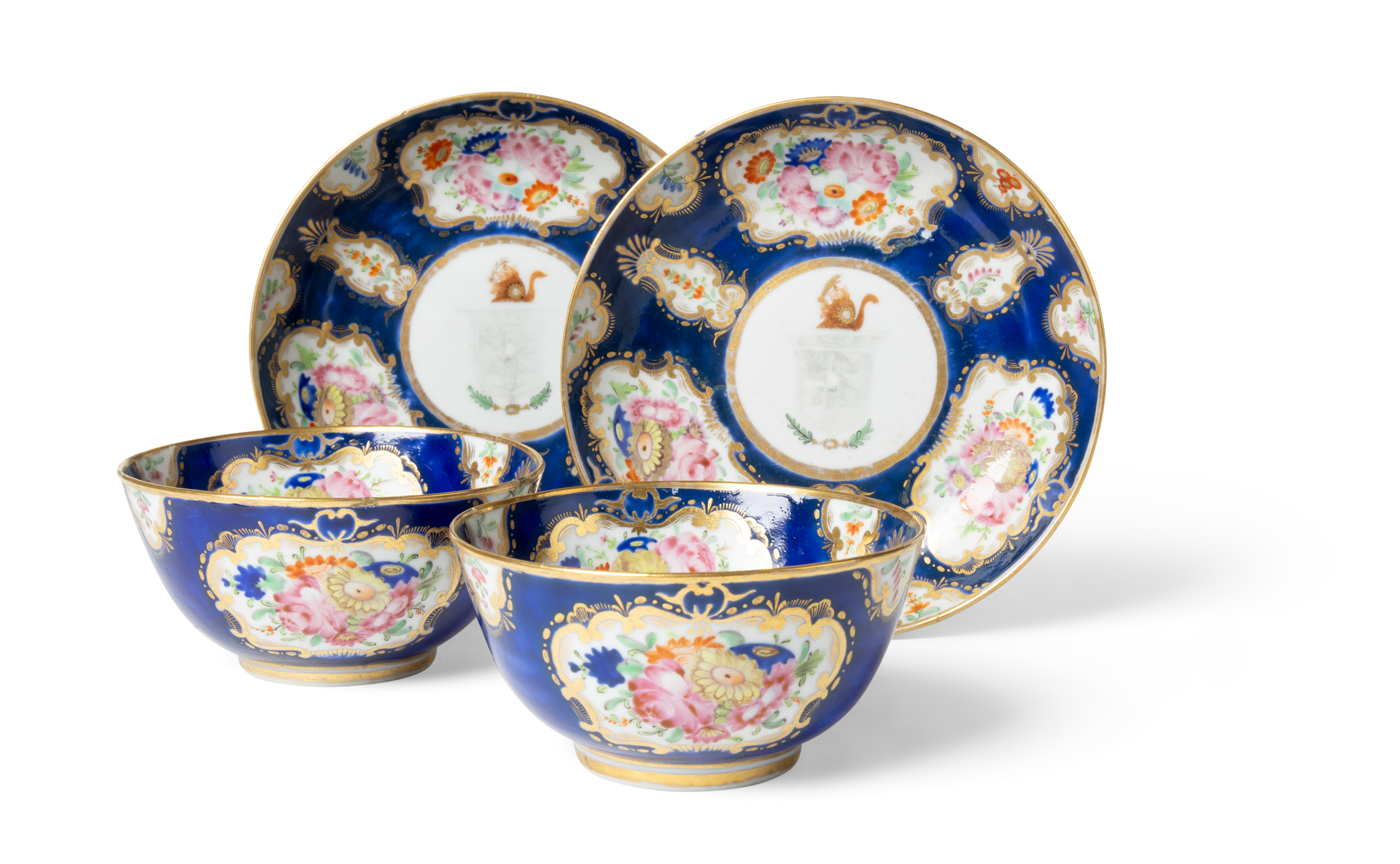 TWO SETS OF CHINESE EXPORT FAMILLE ROSE ARMORIAL CUPS AND SAUCERS FOR THE ENGLISH MARKET