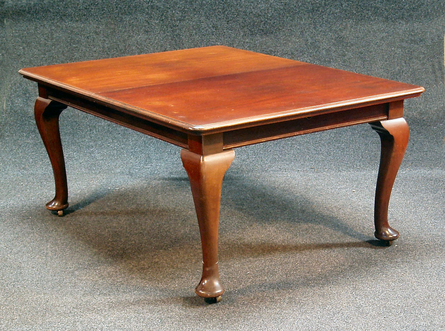 A George II style mahogany dining table,
