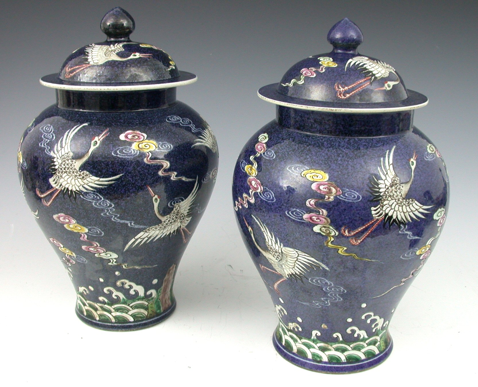 A pair of 20th century Chinese baluster shaped vases and covers