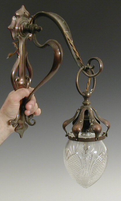 A pair of Art Nouveau copper wall lights,