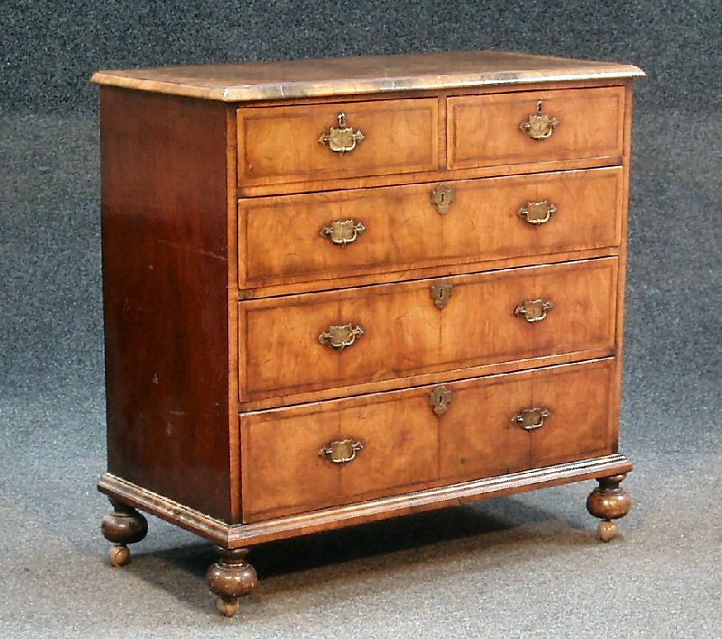 An Edwardian walnut, crossbanded and feather banded chest, in the early 18th century manner