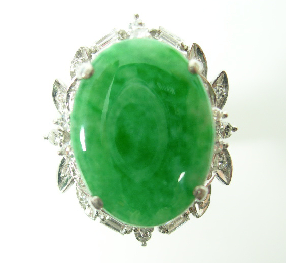 A jade and diamond oval cluster ring,