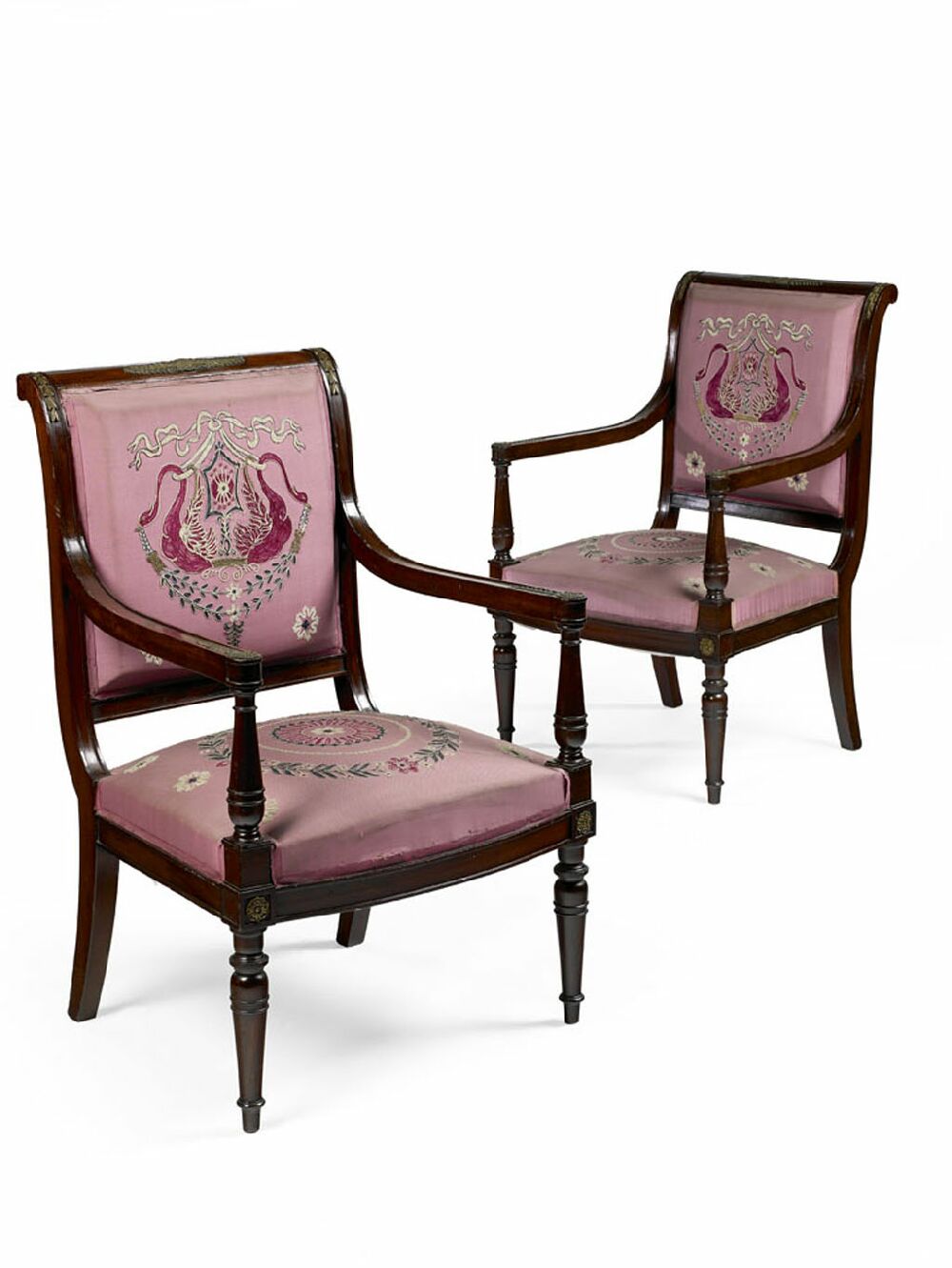 A set of four late 19th century mahogany and upholstered fauteuils, in the Empire style
