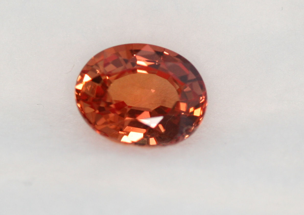 An unmounted oval cut padparadscha sapphire,