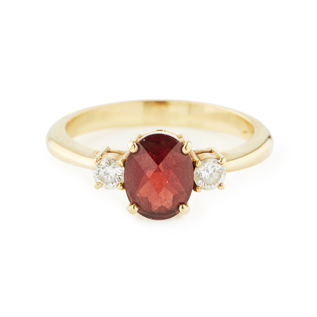 A three stone garnet and diamond set ring