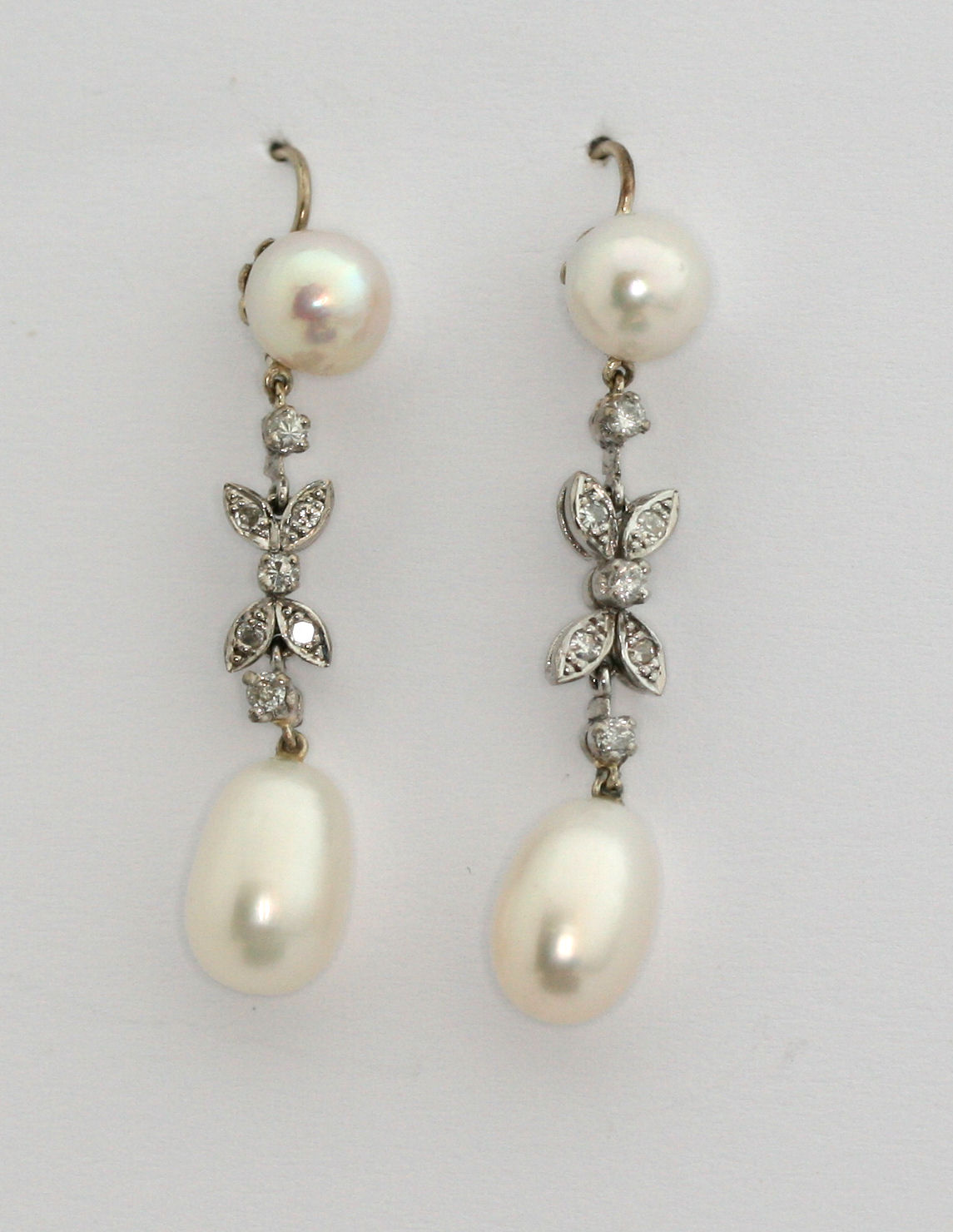 A pair of cultured pearl and diamond pendant earrings,