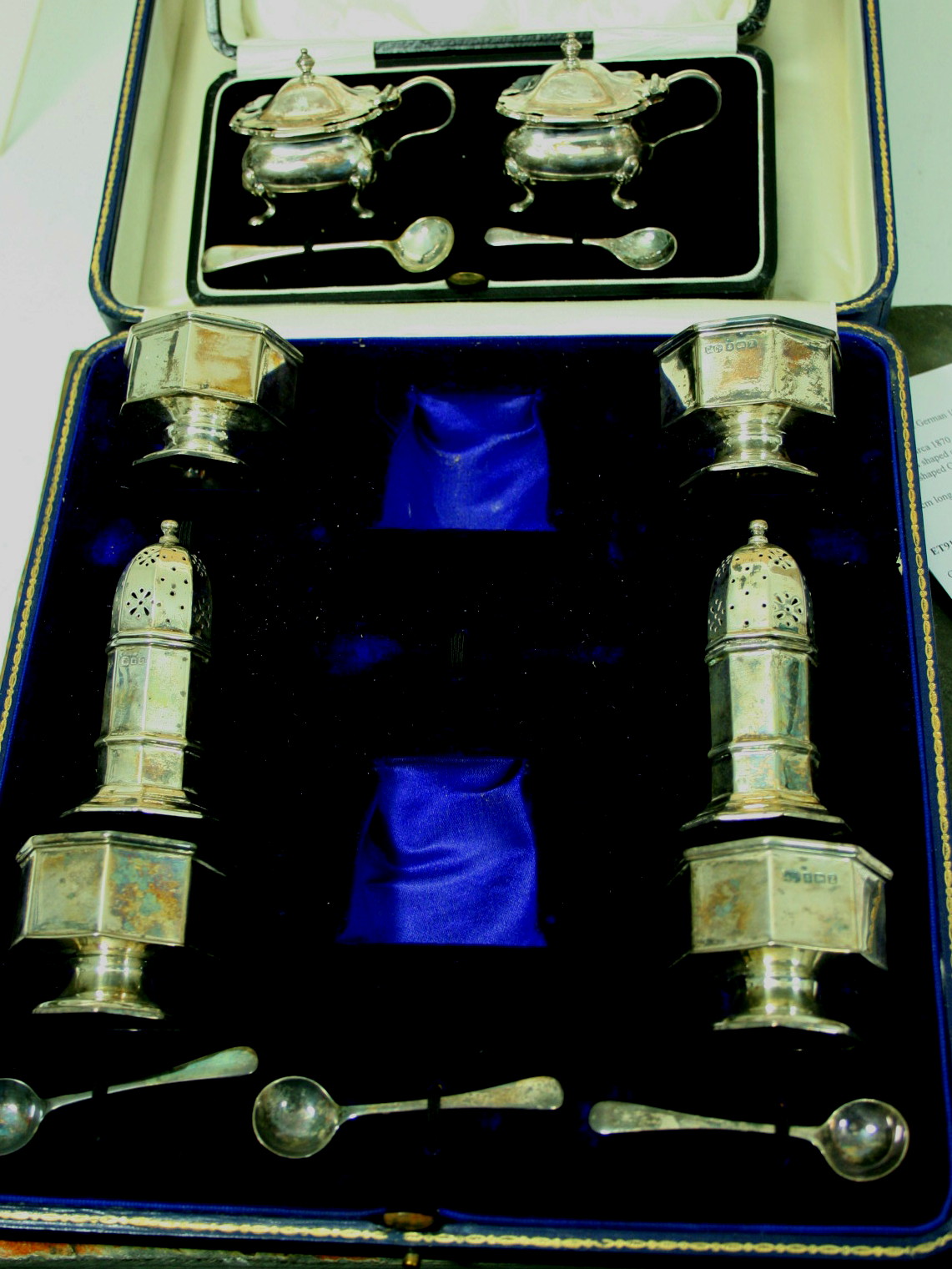 A cased silver part condiment set