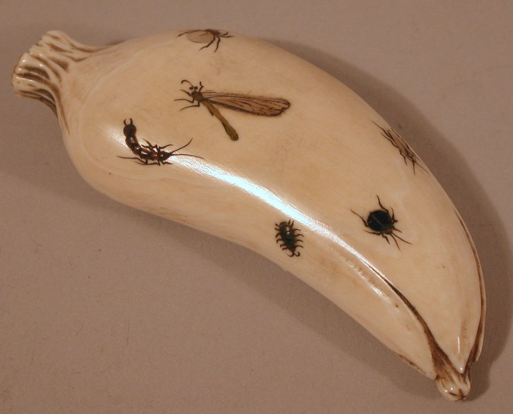 A Japanese carved ivory shibyama decorated long bean