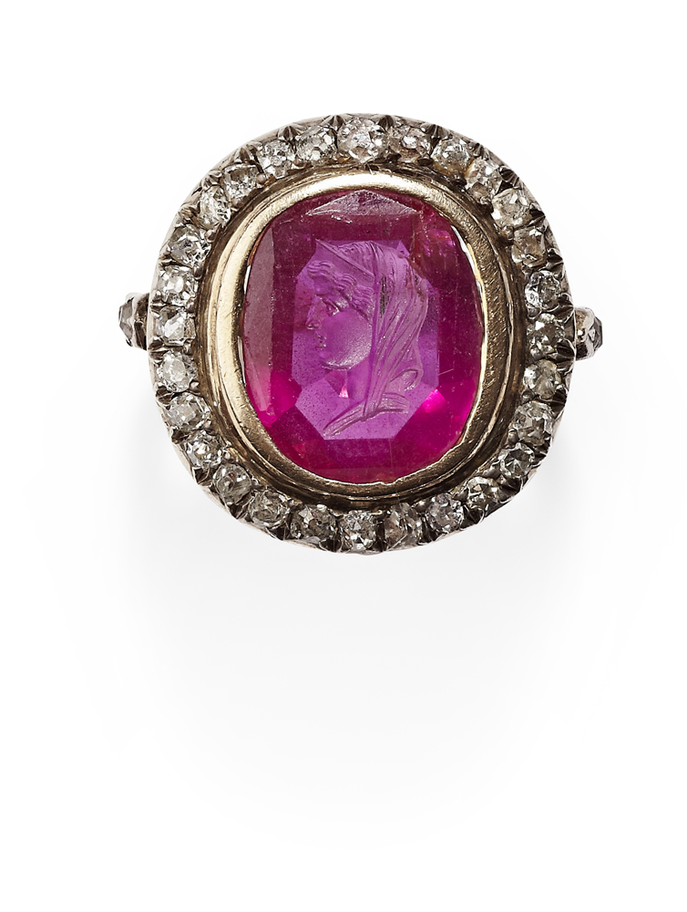 A seal carved ruby and diamond set cluster ring