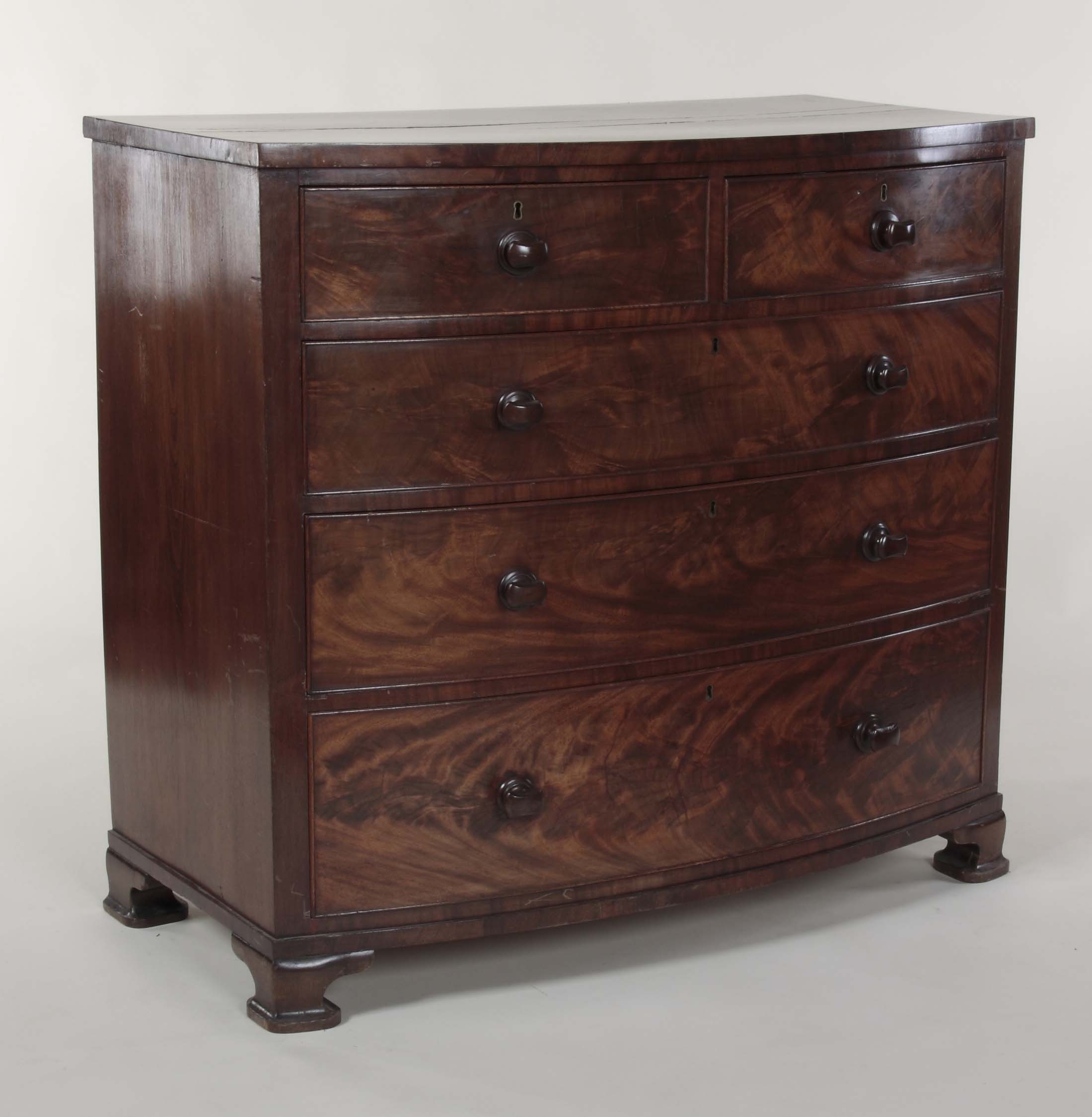 An early 20th century mahogany bow front chest In the manner of Whytock and Reid