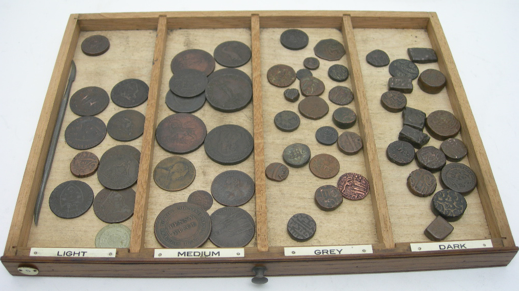 A COIN COLLECTION IN AN OAK COLLECTORS CABINET WITH TWENTY DRAWERS