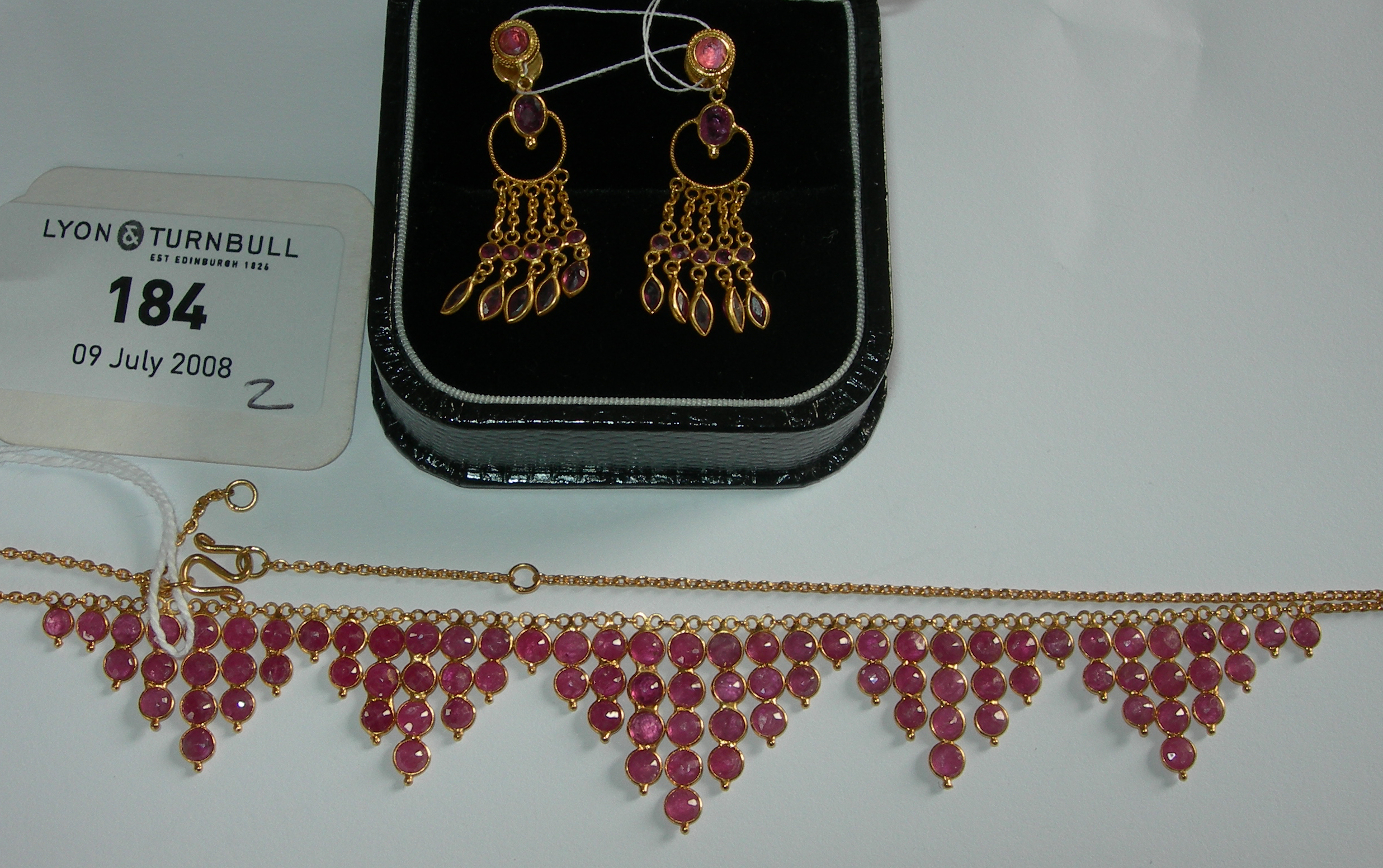 A ruby set necklace and matching pendant earrings,