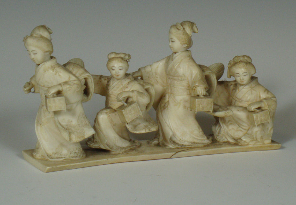 An early 20th century Japanese ivory figure group