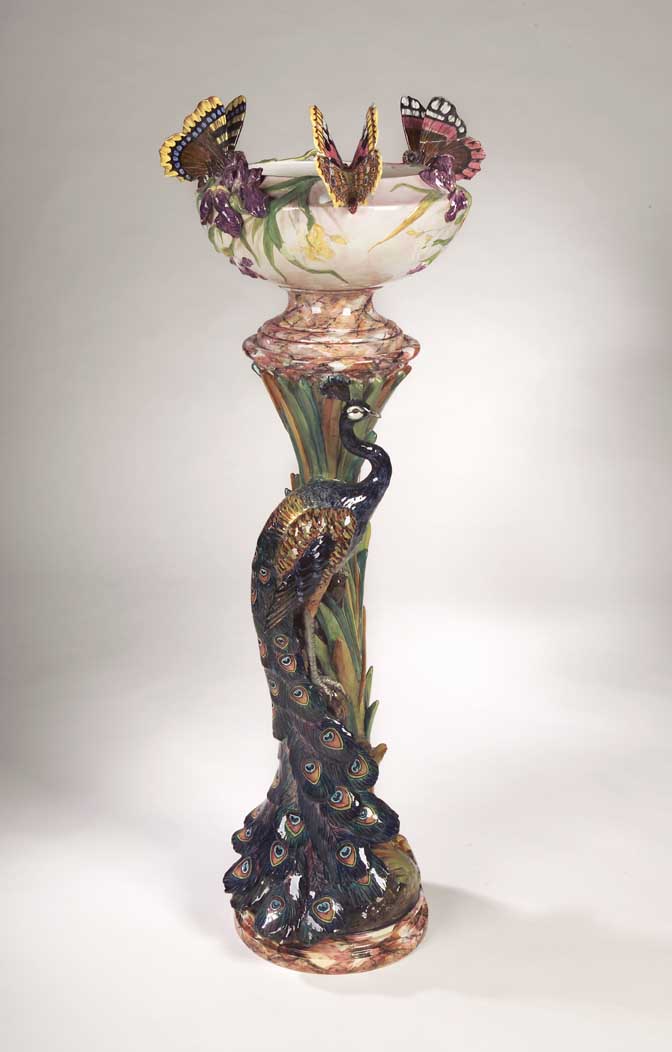 A large Delphin Massier faience jardiniere on stand,