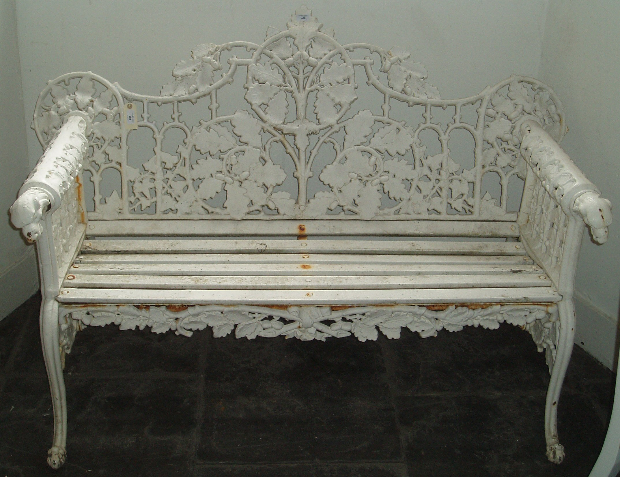 A Victorian over painted cast iron garden bench,