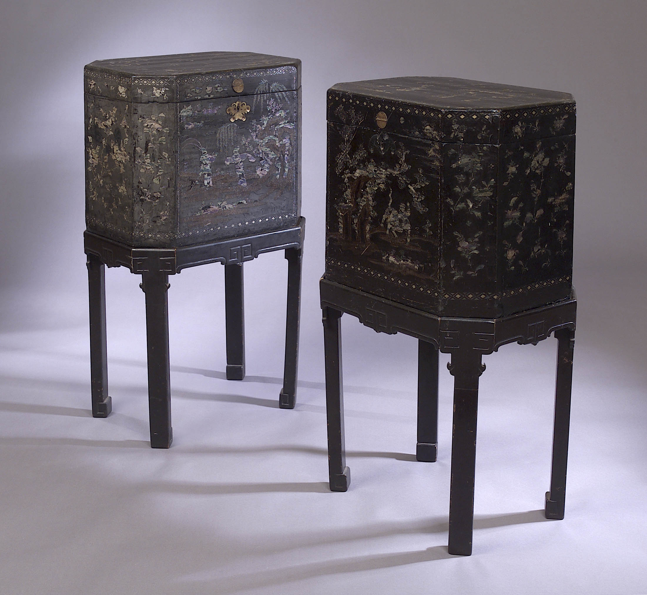 A pair of Chinese black lacquer boxes on stands