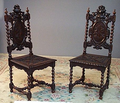 A pair of 19th century oak hall chairs in the Carolean style
