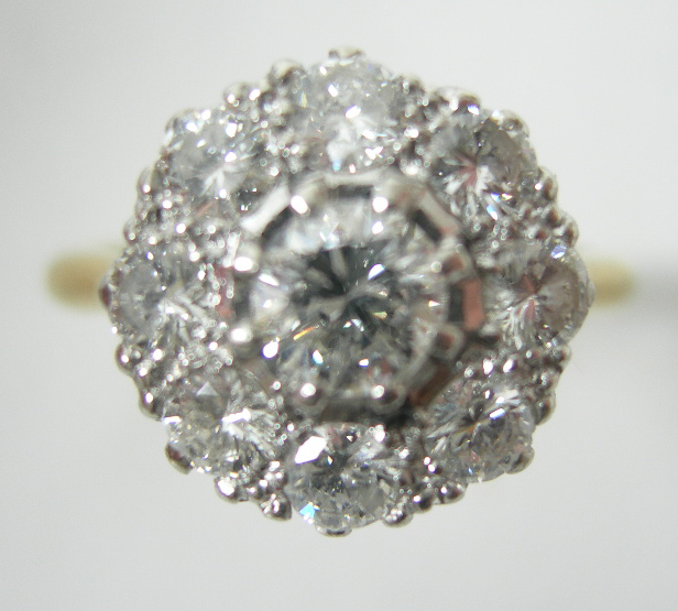 An 18ct gold and platinum mounted diamond cluster ring,