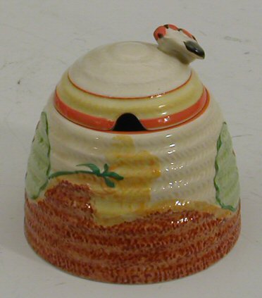 A Clarice Cliff honey pot and cover,