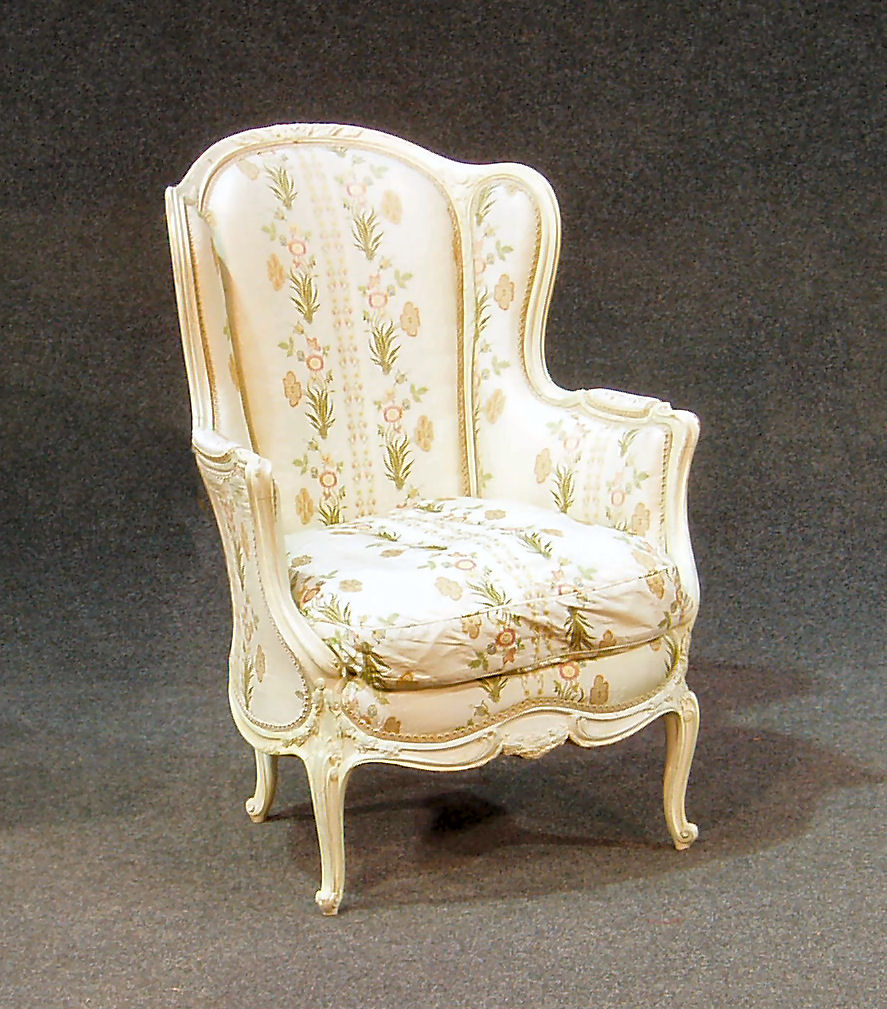 A French style white painted winged back armchair