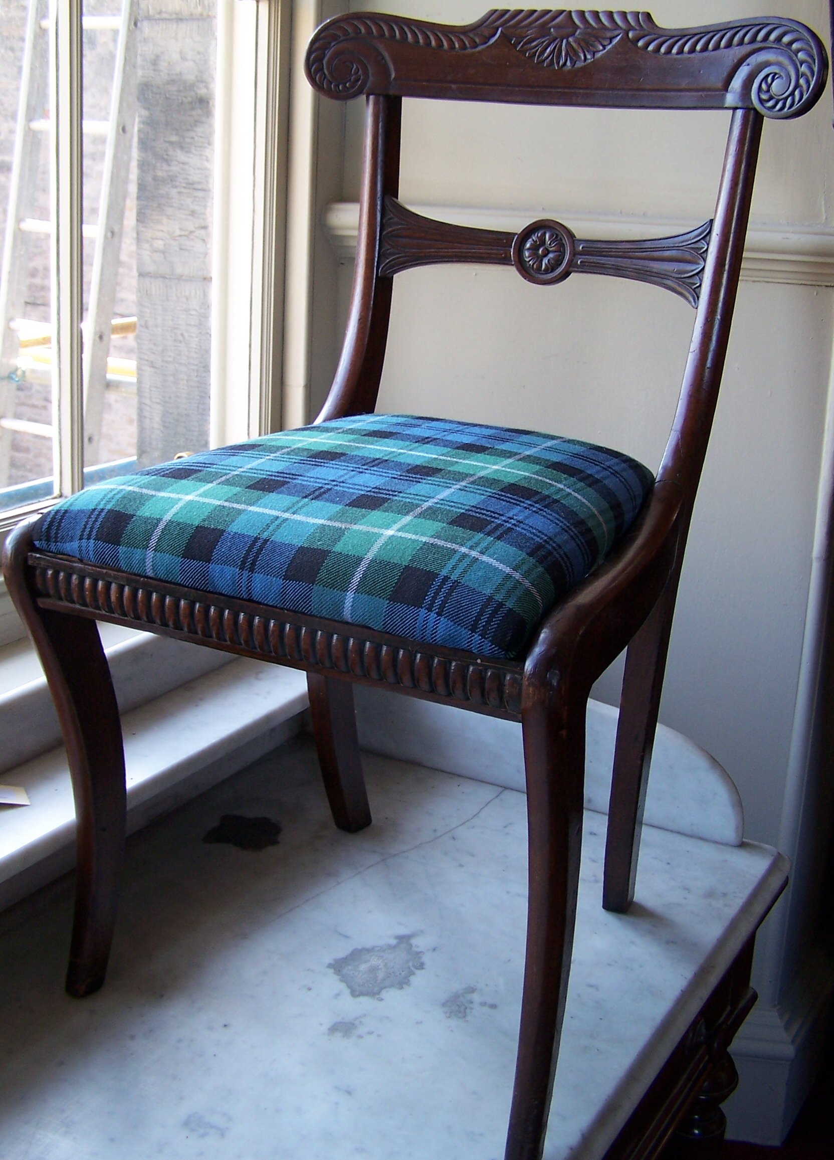 A set of five Regency mahogany dining chairs,