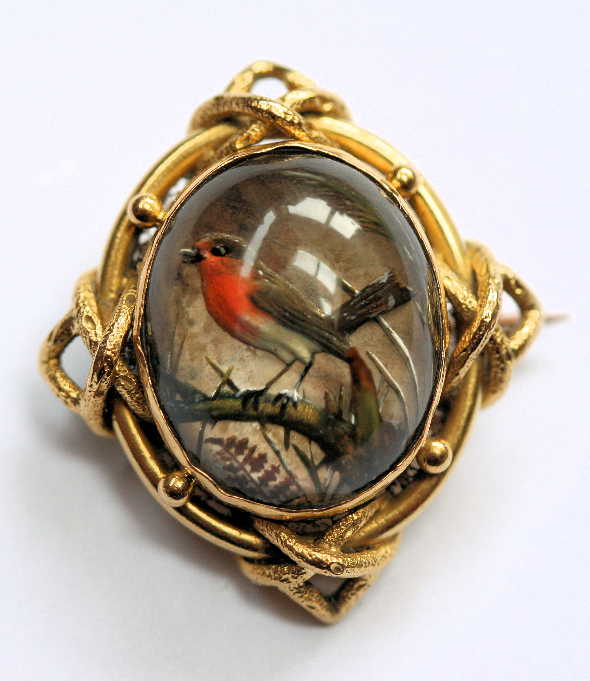 A late Victorian/Edwardian hand-painted reverse crystal intaglio set brooch