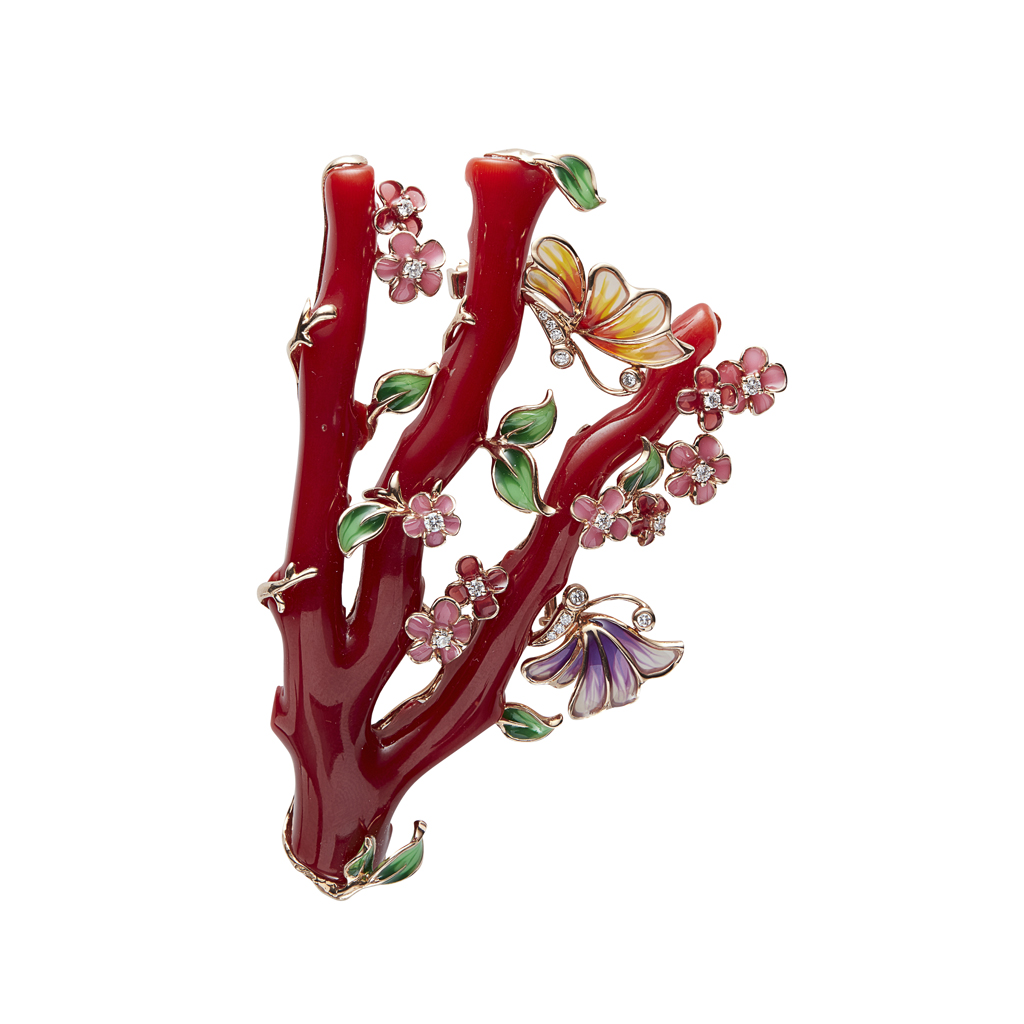 A coral and enamel set brooch