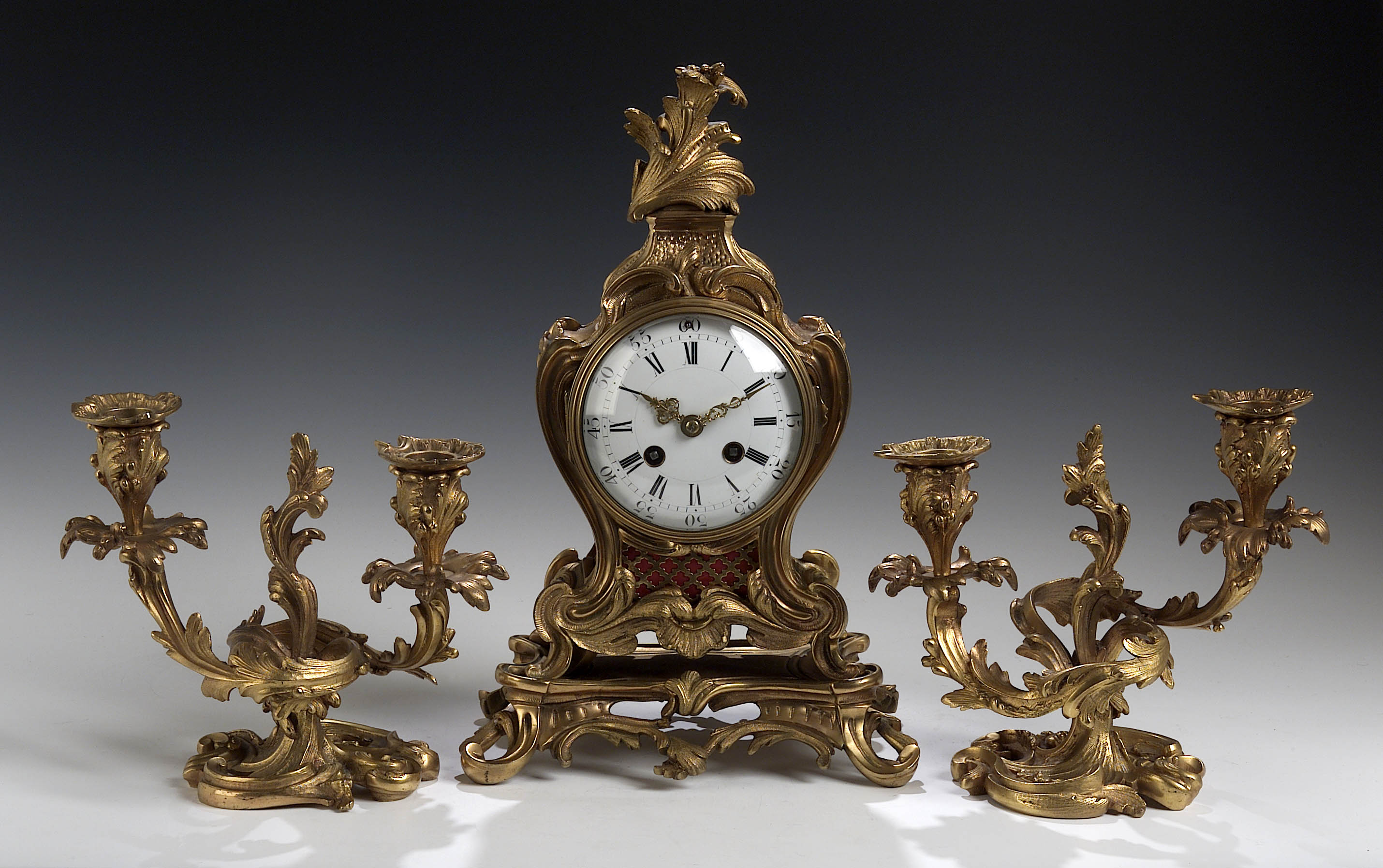 A 19th century French gilt brass clock garniture