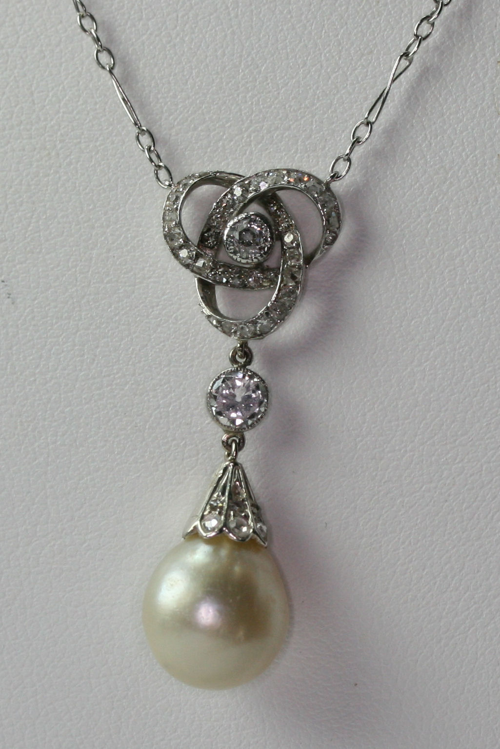 A pearl and diamond set necklace