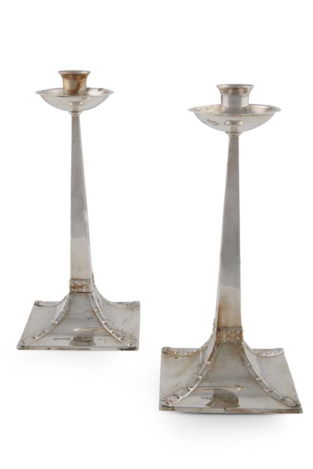 A pair of Arts and Crafts style candlesticks