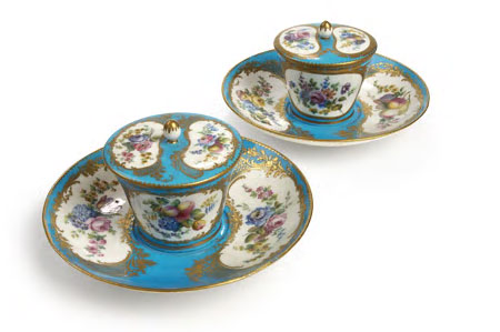 A pair of 19th century Sevres style cups, covers and associated saucers,