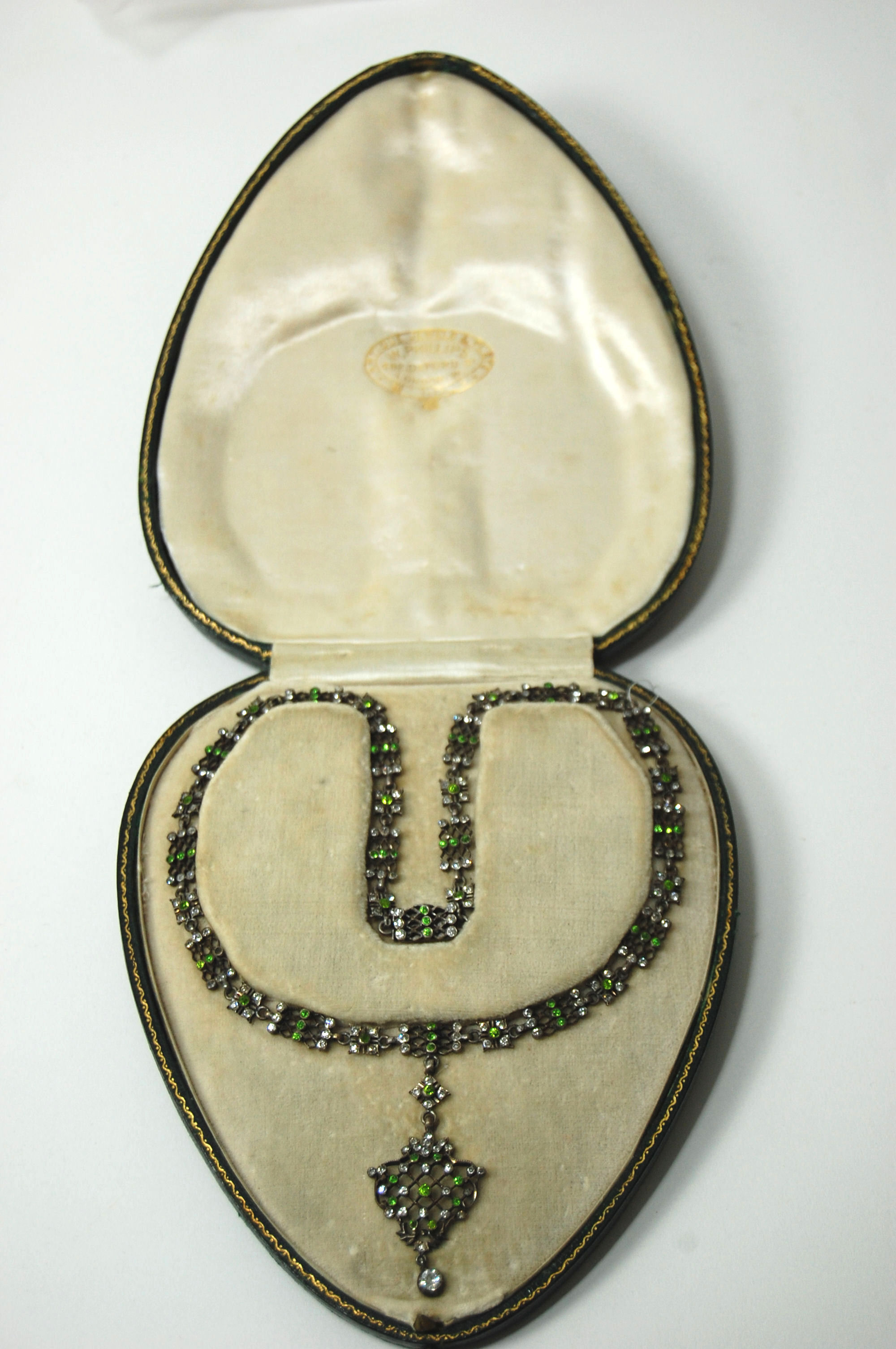 A green and colourless gem set necklace,