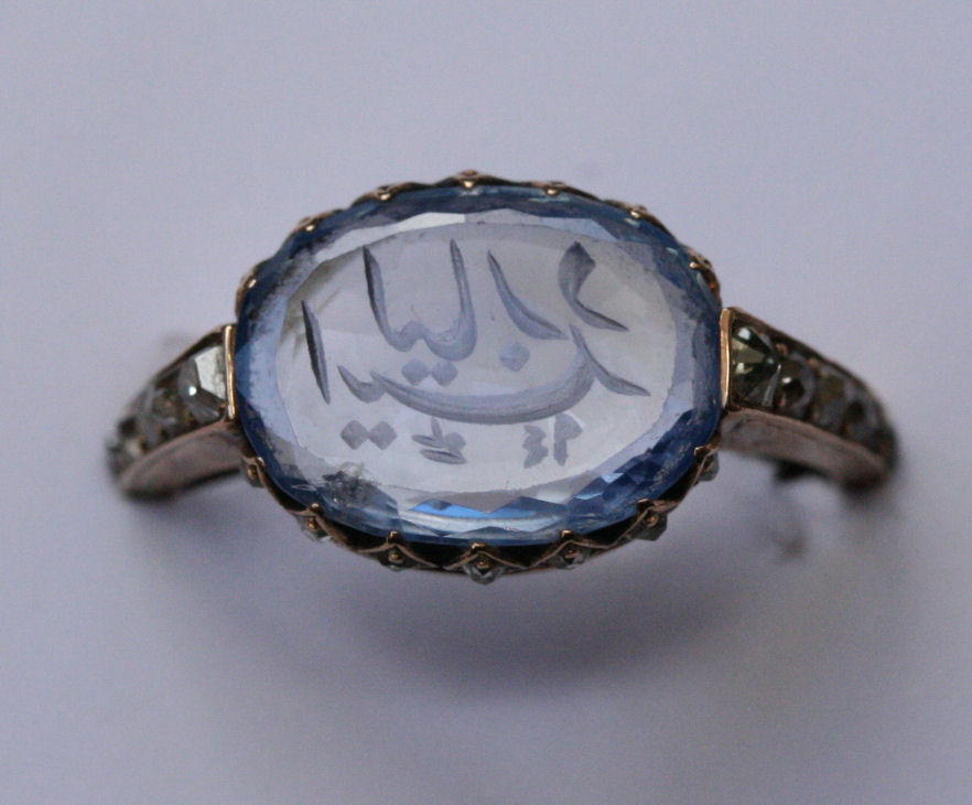 A carved sapphire and diamond set ring
