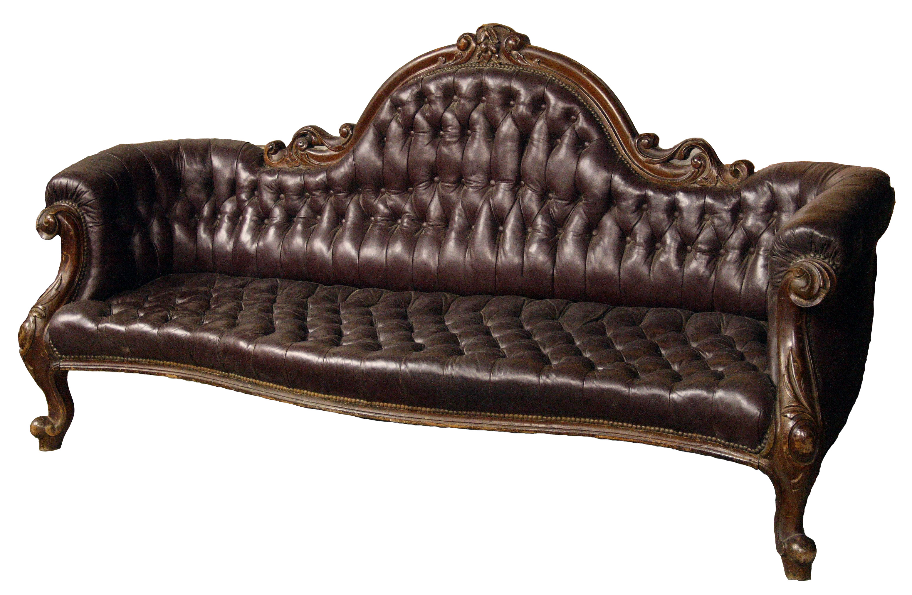 A mid Victorian period walnut and buttoned leather settee