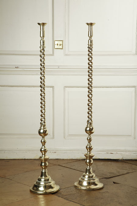 A pair of tall brass candlesticks